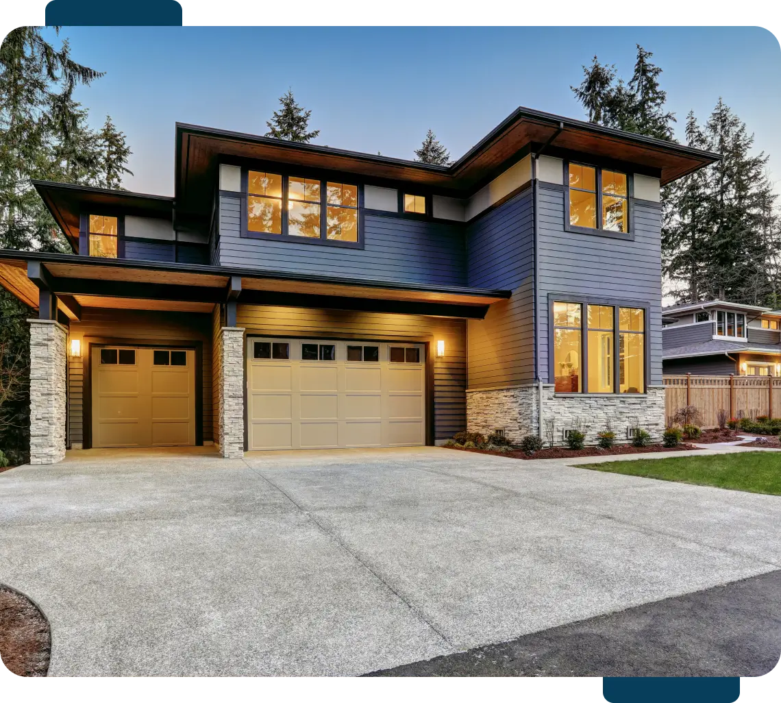 A large blue house with two garage doors.