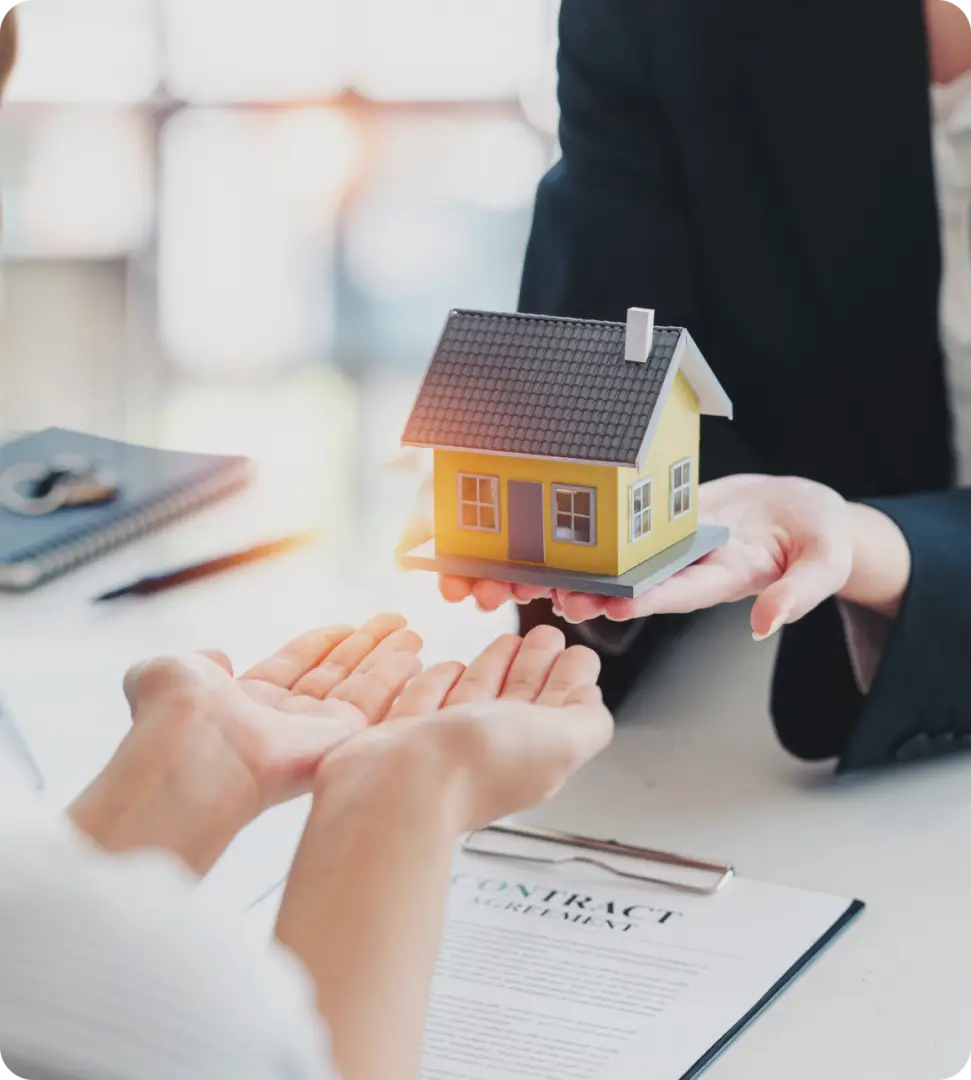 A person is holding out their hands to the house.